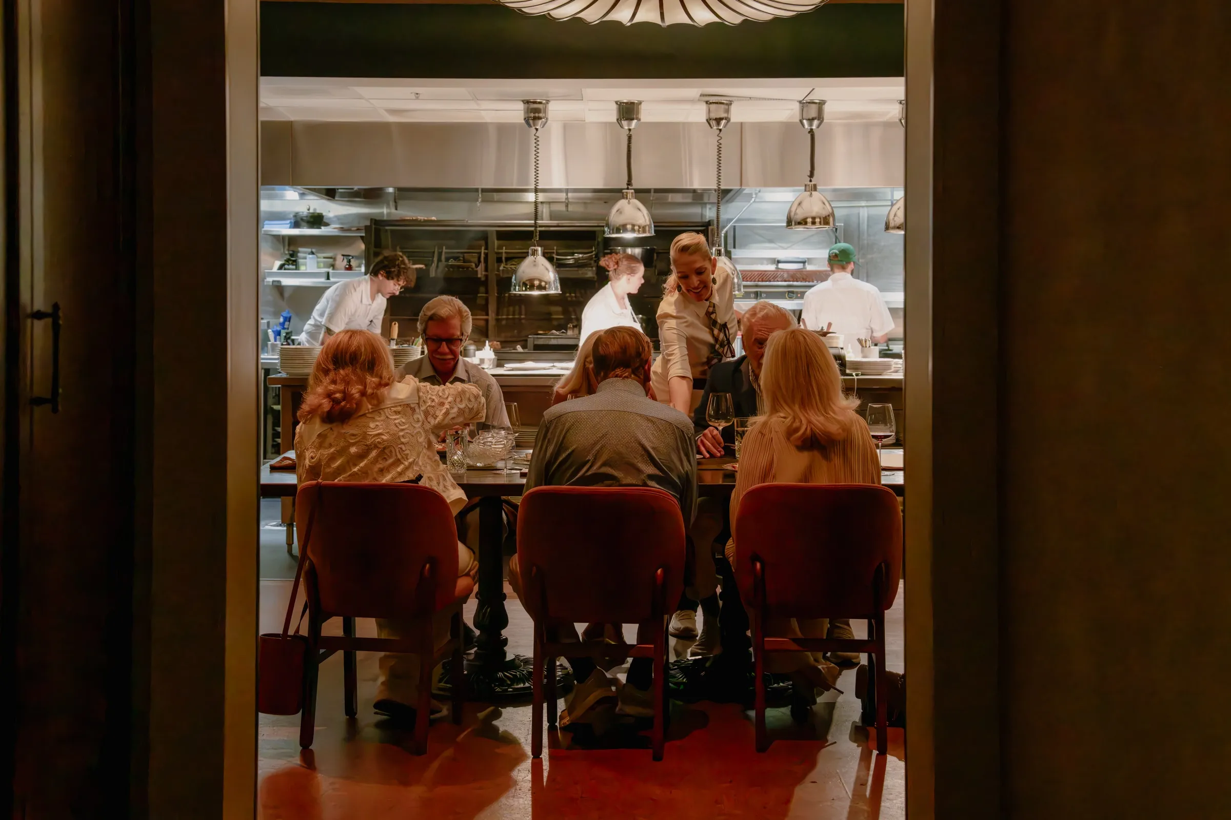 Guests at the Chef’s Table with the open kitchen behind